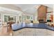 Bright kitchen with blue countertops, island seating, and open view to the living room and dining area at 150 Williamston Ridge Dr, Youngsville, NC 27596