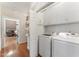 Functional laundry room with washer, dryer, and storage cabinets, leading into the living room at 150 Williamston Ridge Dr, Youngsville, NC 27596
