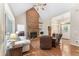 Open living room with hardwood floors, brick fireplace, and plenty of natural light at 150 Williamston Ridge Dr, Youngsville, NC 27596