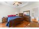 Bedroom featuring hardwood floors, a tray ceiling, and ample natural light at 150 Williamston Ridge Dr, Youngsville, NC 27596