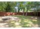 Large, fenced backyard with mature trees and a concrete patio area, perfect for outdoor living at 1611 Poole Rd, Raleigh, NC 27610