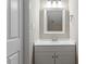 A beautifully designed bathroom featuring a white vanity, modern faucet, and decorative mirror at 1611 Poole Rd, Raleigh, NC 27610