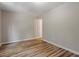 Neutral bedroom featuring wood-look flooring, base molding, and natural light at 1611 Poole Rd, Raleigh, NC 27610