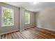 Sunlit bedroom with two large windows and modern flooring, offering a bright and inviting space at 1611 Poole Rd, Raleigh, NC 27610