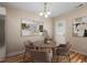 Charming dining area features a stylish round table with seating for four and modern light fixture at 1611 Poole Rd, Raleigh, NC 27610