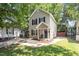 Cozy home featuring black shutters, a quaint front porch and a well-kept front lawn at 1611 Poole Rd, Raleigh, NC 27610