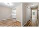 Hallway view of the kitchen and bedroom; featuring updated wood-look flooring at 1611 Poole Rd, Raleigh, NC 27610