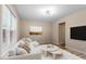 Bright living room features a modern white sofa, wood floors, and neutral decor, perfect for relaxing at 1611 Poole Rd, Raleigh, NC 27610