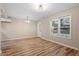 Bright living room with wood-look flooring, neutral walls, with lots of windows for natural light at 1611 Poole Rd, Raleigh, NC 27610