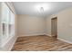 Bright living room with a large window, light fixtures, and neutral paint at 1611 Poole Rd, Raleigh, NC 27610