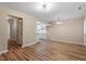 Spacious living room with wood-look flooring, neutral walls, offering a view into the kitchen at 1611 Poole Rd, Raleigh, NC 27610