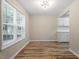 Well-lit living area featuring modern flooring, a large window, and access to the kitchen at 1611 Poole Rd, Raleigh, NC 27610