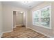 Open living room with natural light from windows, showcasing modern flooring and neutral paint at 1611 Poole Rd, Raleigh, NC 27610
