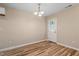 Bright living room featuring wood floors, chandelier lighting, and a white door to the backyard at 1611 Poole Rd, Raleigh, NC 27610