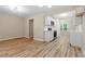 Spacious living room with wood-look flooring, neutral walls, and plenty of natural light at 1611 Poole Rd, Raleigh, NC 27610