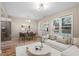 Cozy living room that flows into the dining area, featuring a comfortable couch and modern stainless fridge at 1611 Poole Rd, Raleigh, NC 27610