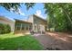 The backyard features an exterior elevation with a patio and yard with trees at 1909 Piperwood Ct, Durham, NC 27713