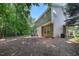 The backyard features an exterior elevation with a patio and yard with trees at 1909 Piperwood Ct, Durham, NC 27713