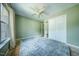 Carpeted bedroom featuring a ceiling fan, neutral walls, and a bright window at 1909 Piperwood Ct, Durham, NC 27713