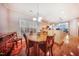 Bright dining room with a wood table, chairs, and hardwood floors; adjacent to the kitchen at 1909 Piperwood Ct, Durham, NC 27713