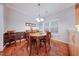 Cozy dining room with a round wood table, comfortable chairs, and natural light from the window at 1909 Piperwood Ct, Durham, NC 27713