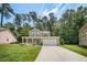 Charming two-story home with a well-maintained lawn, inviting front porch, and a two-car garage at 1909 Piperwood Ct, Durham, NC 27713