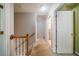 Upstairs hallway with carpet, showing access to bedrooms and bathroom at 1909 Piperwood Ct, Durham, NC 27713