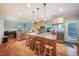 Bright kitchen with stainless steel appliances, hardwood floors, island with seating, and ample cabinet space at 1909 Piperwood Ct, Durham, NC 27713
