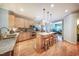 Well-equipped kitchen with stainless steel appliances, a center island with seating, and wood floors at 1909 Piperwood Ct, Durham, NC 27713
