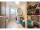 Functional laundry room with stacked washer and dryer and storage shelving at 1909 Piperwood Ct, Durham, NC 27713