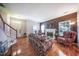 Bright living room featuring a fireplace, comfortable furniture, and hardwood floors at 1909 Piperwood Ct, Durham, NC 27713