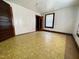 Spacious empty bedroom featuring hardwood trim, a single window and functional, patterned flooring at 229 Maple Dr, Oxford, NC 27565