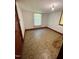 A bedroom featuring neutral-toned walls, vintage flooring, and natural light from the windows at 229 Maple Dr, Oxford, NC 27565