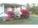 Inviting home exterior featuring lush azalea bushes in full bloom and a well-maintained lawn at 229 Maple Dr, Oxford, NC 27565
