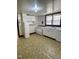 Retro kitchen featuring white appliances and cabinetry, illuminated by a functional light fixture at 229 Maple Dr, Oxford, NC 27565