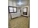 Vintage kitchen with white cabinets, retro appliances, and bright, natural light streaming through the windows at 229 Maple Dr, Oxford, NC 27565