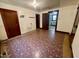 A living room featuring neutral-toned walls with vintage flooring and a glimpse into the kitchen at 229 Maple Dr, Oxford, NC 27565