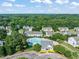 A beautiful aerial shot showcases a community pool surrounded by lush greenery and manicured lawns at 2833 Gross Ave, Wake Forest, NC 27587