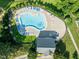 Aerial view of a pool with blue lounge chairs around it and the words 