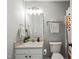 This bathroom features a sink with double cabinets, a mirror, and a towel rack at 2833 Gross Ave, Wake Forest, NC 27587