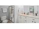 Bright bathroom featuring double sinks with white cabinetry and a glass door shower at 2833 Gross Ave, Wake Forest, NC 27587