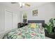 Bright bedroom features a leafy bedspread, ceiling fan, and a built in desk at 2833 Gross Ave, Wake Forest, NC 27587