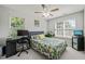 This bedroom has great natural light, a ceiling fan, and charming leafy bedding at 2833 Gross Ave, Wake Forest, NC 27587