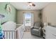 This Bedroom features neutral walls, a glider chair, and a white crib at 2833 Gross Ave, Wake Forest, NC 27587