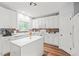 Bright kitchen featuring white cabinets, stainless steel appliances, and a kitchen island at 2833 Gross Ave, Wake Forest, NC 27587