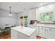 Kitchen with an island, stainless steel appliances, mosaic tile backsplash, and an adjacent dining area at 2833 Gross Ave, Wake Forest, NC 27587