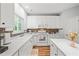 Bright kitchen featuring white cabinets, stainless steel appliances, and a mosaic tile backsplash at 2833 Gross Ave, Wake Forest, NC 27587