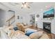 Cozy living room with fireplace, ceiling fan, hardwood floors, and staircase access at 2833 Gross Ave, Wake Forest, NC 27587