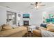 Bright living room with fireplace, ceiling fan, hardwood floors, and comfortable seating area at 2833 Gross Ave, Wake Forest, NC 27587