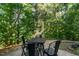 The patio features an outdoor table and four chairs, set among trees at 2833 Gross Ave, Wake Forest, NC 27587